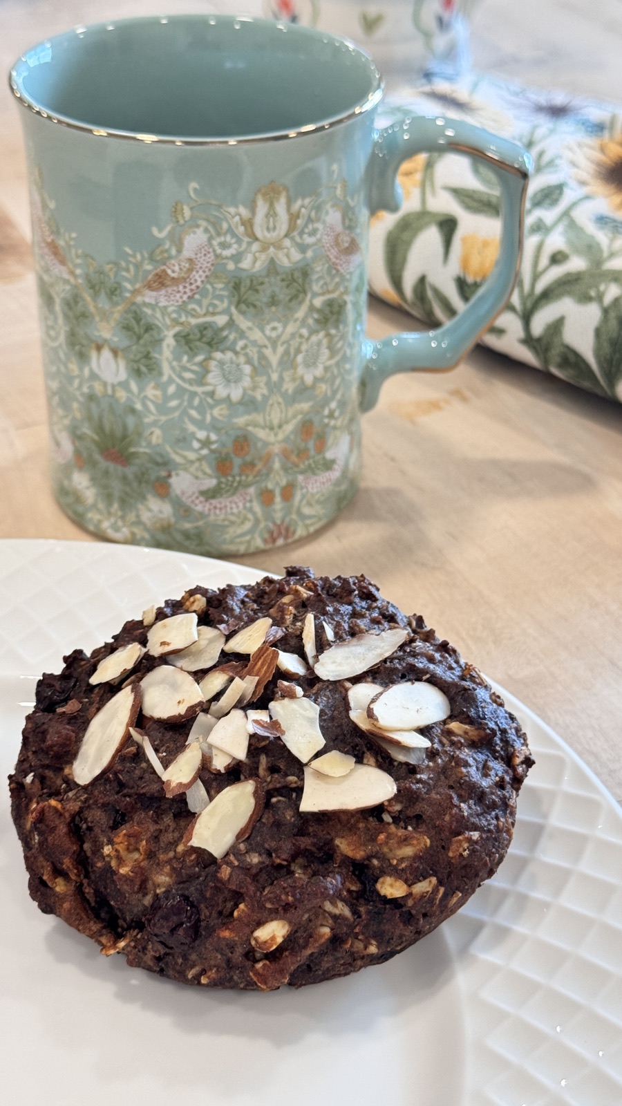 Chocmondu cookie beside a floral ceramic mug