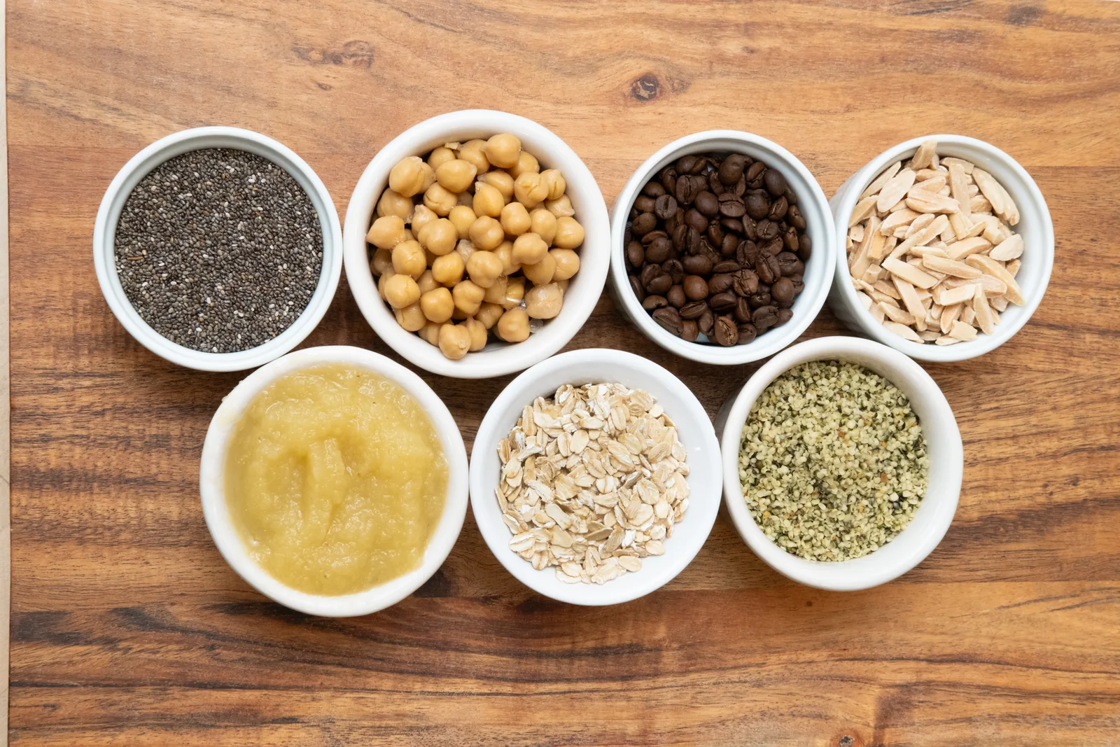 Bowls of cookie ingredients arranged on a wooden table