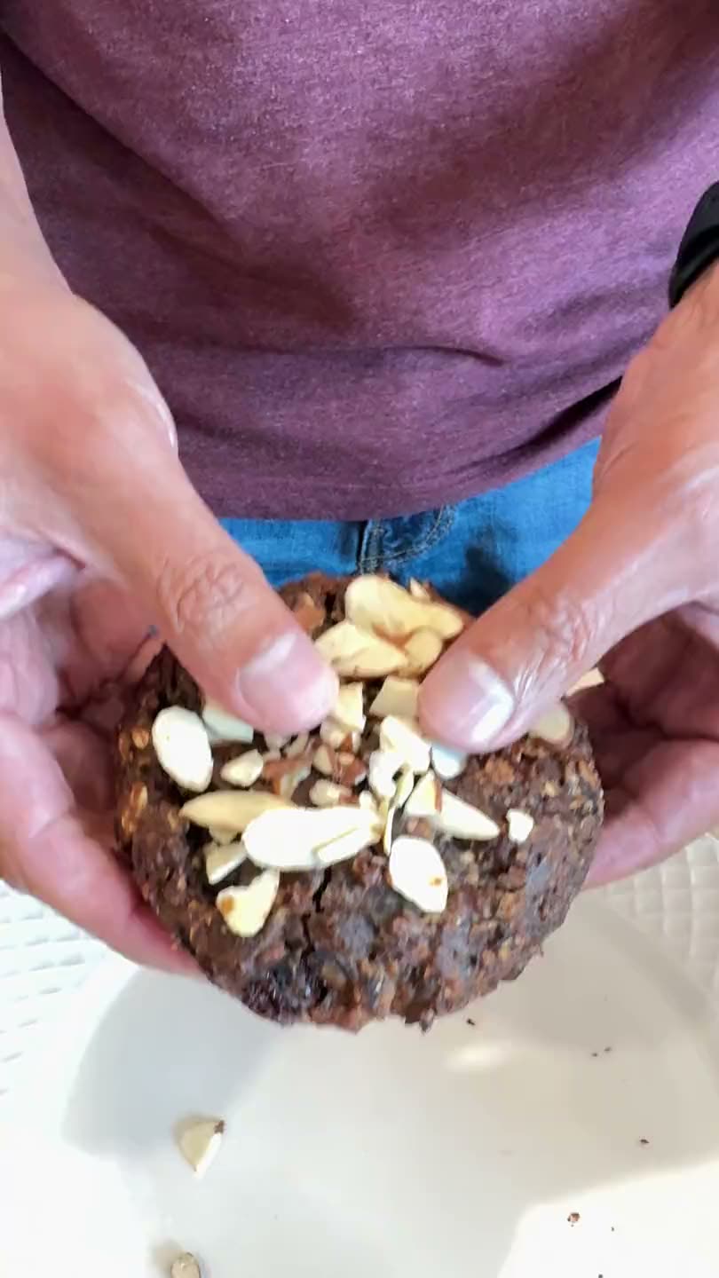 Hands breaking a Cookie Not Cookie in half, showing the soft interior